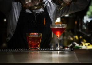 bartender mixing alcohol in bar