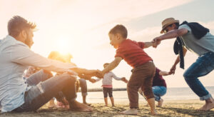 family playing at beach at Cutarelli Vision