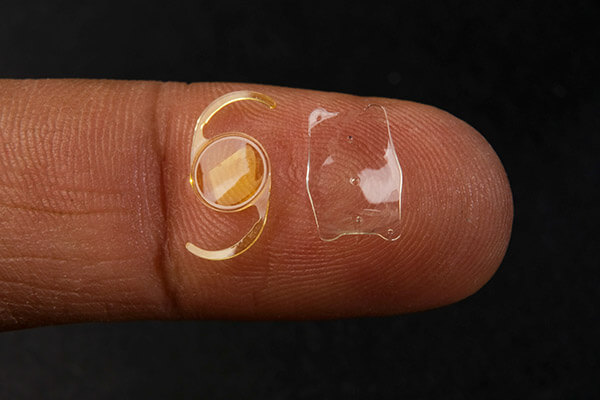 Closeup of Lens Implants on a Finger