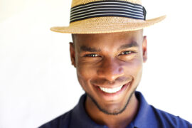 man smiling while wearing a hat at Cutarelli Vision