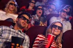 people wearing 3d glasses at movie theatre