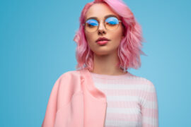 Young woman with pink hair and stylish glasses
