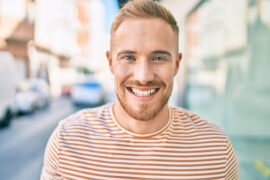 Young Irish Man Smiling Happy Walking On A City Street
