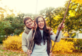Smiling Couple Using a Swing