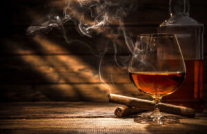 Photo of a cigar and glass of scotch