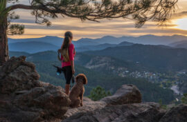 woman hiking with her dog