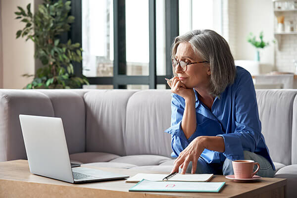 Woman Thinking While Using Her Computer