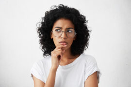 woman with glasses thinking about LASIK candidate at Cutarelli Vision
