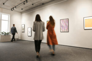 women walking at modern art gallery exhibition